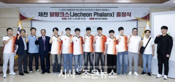 여러 명의 남성이 제천 팔랑크스(Jecheon Phalanx) 출정식 현수막 앞에서 단체로 포즈를 취하고 있다. 일부는 유니폼을 입고 있으며, 모두 엄지손가락을 들어 올리고 있다.